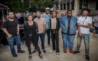 a group of people posing for a photo at an outdoor event